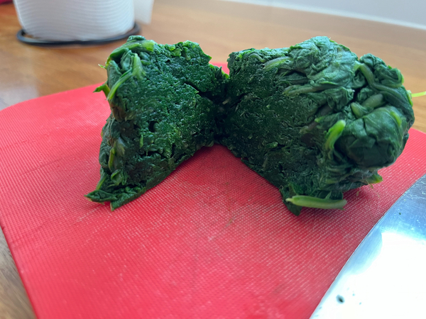 A lump of cooked, squeesed Warrigal Greens ready for chopping.